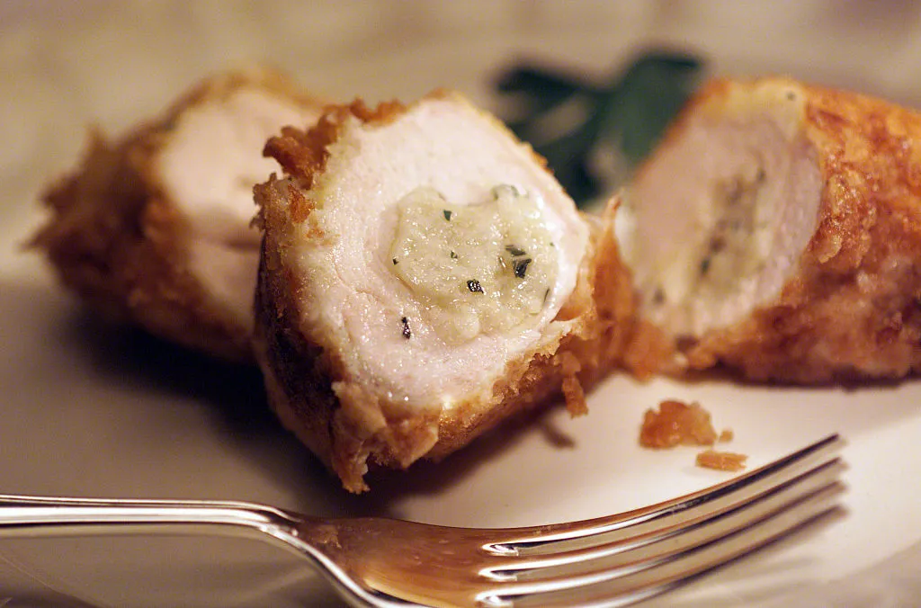 chicken kiev on a plate with a fork