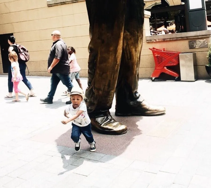 a kid running away from a statue 