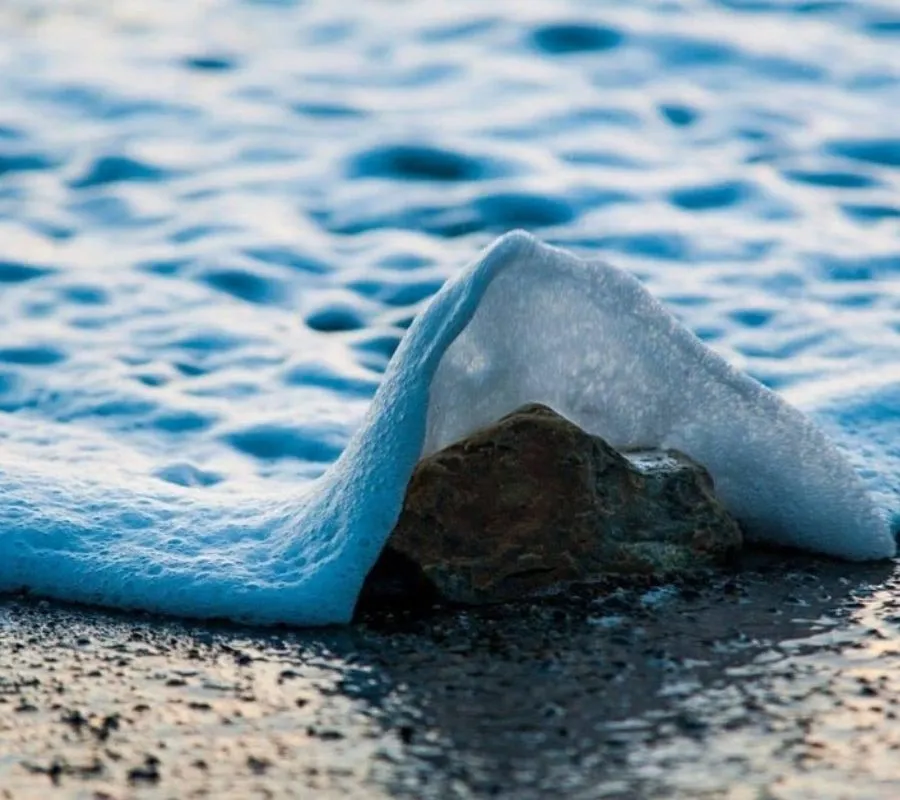 a wave coming over a stone