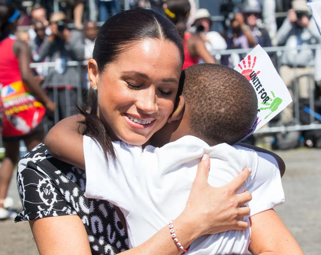 Meghan-hugs-child-1176960486