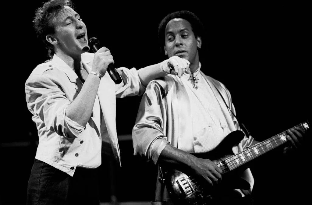 Julian Lennon performs next to his guitarist.