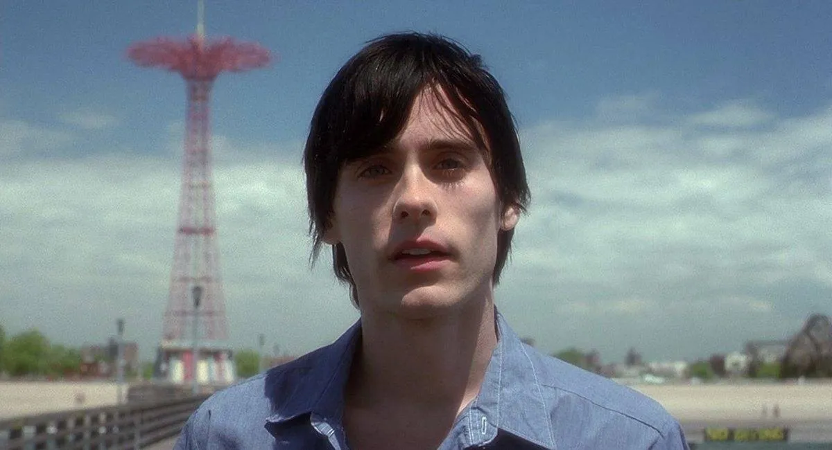 jared leto in front of a red tower