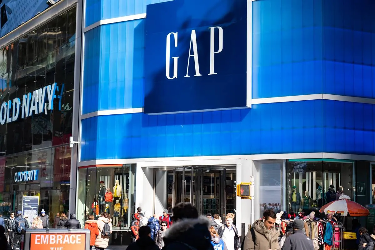 Pedestrians walk past an American worldwide clothing and...