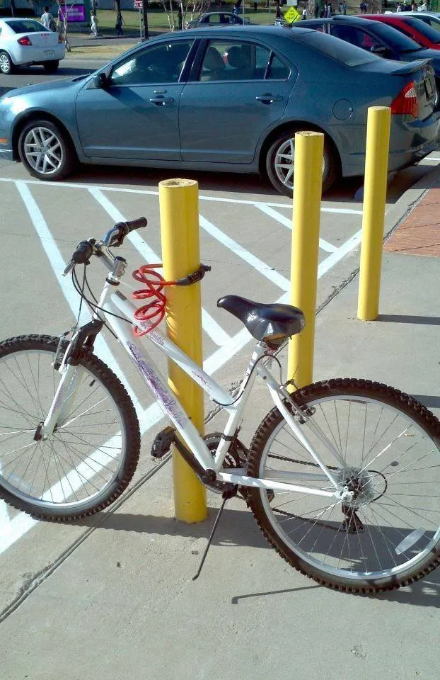 bike that is chained to a pole it can just be lifted off of