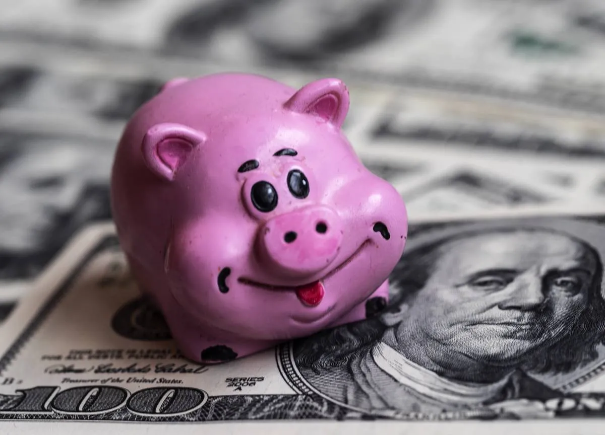 A ceramic pig seen with a background of dollar bills...