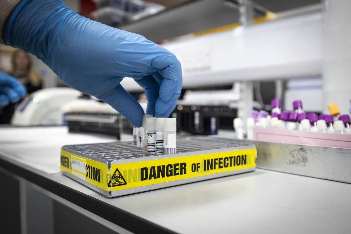 A scientist handles vials of infectious viruses.