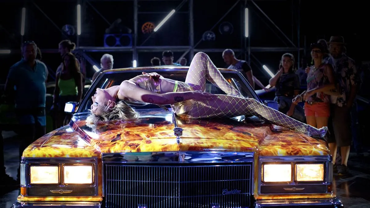 woman dancing in bikini on a cadillac